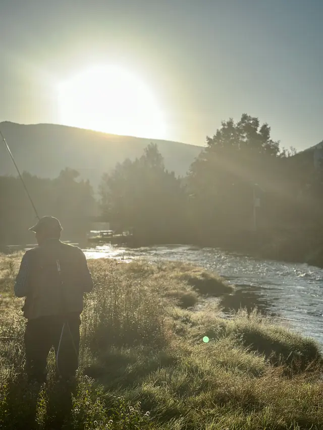 Angler playing a fish in a fast river
